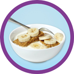 A bowl of wheet bix with milk and sliced banana